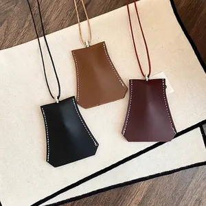 Set of three leather clochette key holder necklaces in black brown and burgundy
