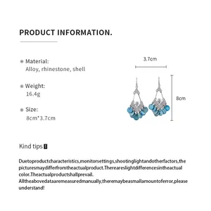 Gedetailleerde productinfo voor etnische strass-schelp oorbellen met maataanduiding.
