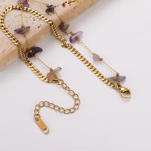 Detail shot of a double-layered gold Cuban chain bracelet with purple stones