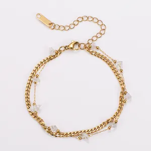 Close-up detail of double-layer Cuban chain bracelet with irregular stones in 18k gold finish.