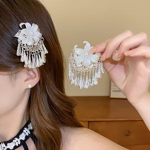 Close-up of elegant New Chinese style pearl flower hair clip with silver tassels
