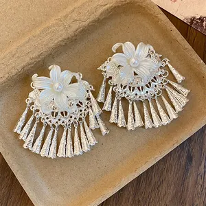 Close-up of pearl flower hair clips with silver tassels in New Chinese style