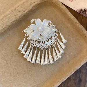 Close-up of elegant New Chinese style silver hair clip with pearl flower and tassels