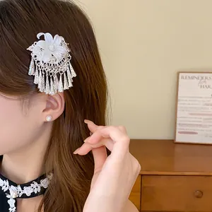 Close-up view of elegant Chinese style hair clip with white flower and silver pearl tassels