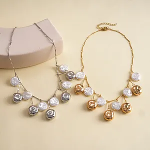 Detail of vintage metallic hammered and pearl disc fringe necklaces in gold and silver tones.