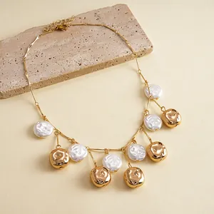 Detailed view of vintage gold metallic wrinkled bead and white pearl fringe necklace
