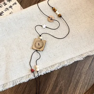 Close-up of vintage New Chinese style necklace with wooden beads and button pendant