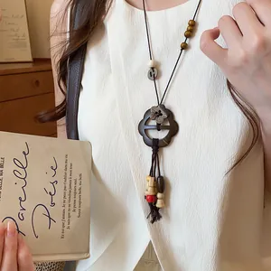 Close-up of New Chinese style flower pendant necklace with wooden beads and tassels