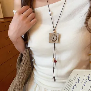 Close-up of a vintage ethnic style pendant necklace with wooden button design