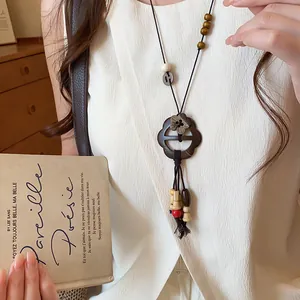 Close-up of a New Chinese style flower button necklace with wooden beads and tassels