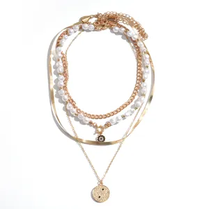 Elegant 4-piece layered gold-tone necklace set featuring pearls and yin-yang pendant