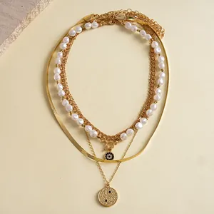 Multi-layered gold-tone chain necklace set with faux pearls and textured round pendants