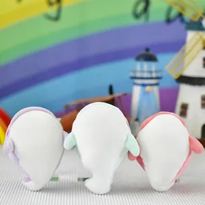 Detailed bottom view of three cute colorful whale plush toy pendants for backpacks