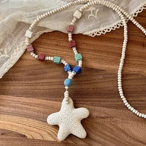 Detailed macro view of colorful volcanic stone beads and a white starfish pendant necklace