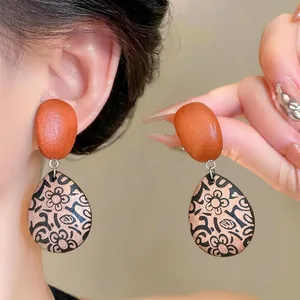 Vintage ethnic style wooden drop earrings with floral pattern and silver needle studs