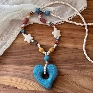 Detailed view of the vibrant colorful lava stone heart pendant and star beads necklace