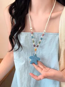 Detailed view of a blue lava stone starfish pendant on a colorful beaded necklace.