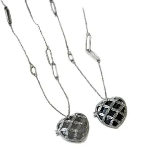 Elegant French luxury acrylic heart pendant necklace with rhinestone metal cage detail