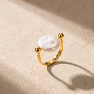 Detailed view of the elegant 18K gold plated ring with a large central pearl.