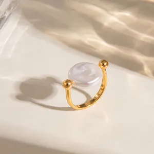 Detail of 18K gold plated stainless steel ring with a large white flat baroque pearl