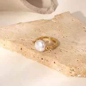Close-up of elegant 18K gold plated stainless steel ring with large pearl detail