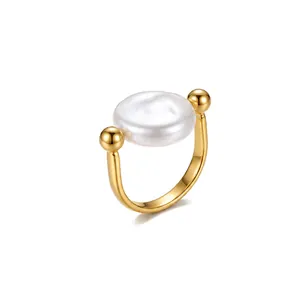 Detail of a 18K gold-plated stainless steel ring featuring a large flat white pearl