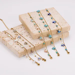Detailed view of gold-tone double-layer bracelets with colorful starfish and beads