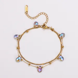 Detail view of double-layer stainless steel bracelet with iridescent teardrop beads