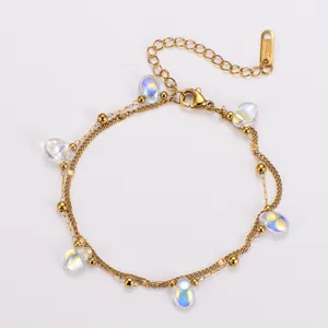 Detailed view of gold double-layer stainless steel bracelet with iridescent charms