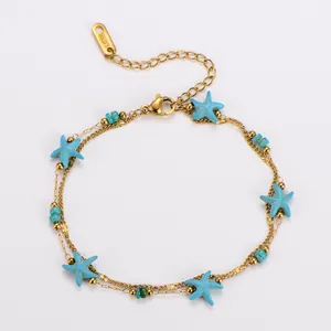 Detail view of gold stainless steel double-layer bracelet featuring blue starfish charms