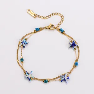 Detail view of double-layer stainless steel bracelet with blue starfish and beads