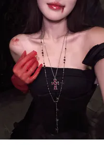 Gothic style double-layer beaded necklace featuring a red gemstone cross pendant.