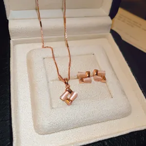 Elegant rose gold cat's eye geometric jewelry set featuring necklace and stud earrings