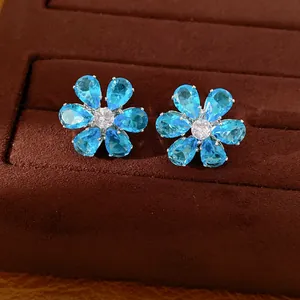 Close-up view showing the intricate blue zircon flower design of the stud earrings