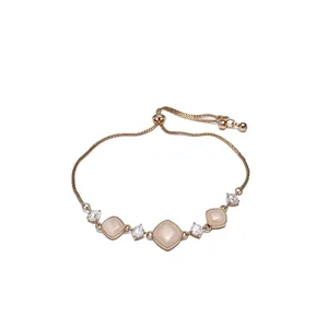 Rose gold adjustable bracelet with square peach stones and sparkling clear zircons.
