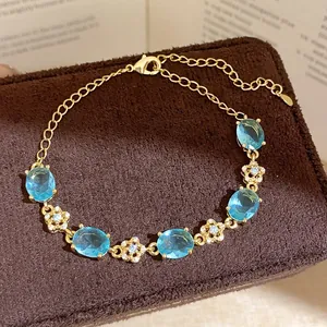Elegant gold-plated bracelet featuring sky blue oval zircons and floral accents jewelry