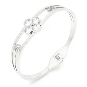 Silver-toned stainless steel double-band bangle featuring crystal clover charms and spring clasp