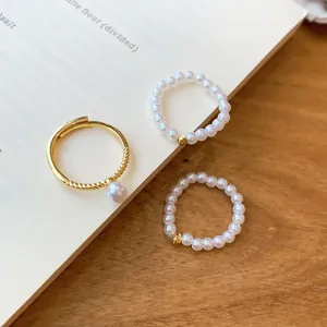 Vue détaillée d'un ensemble de bagues en perles vintage avec anneau ouvert plaqué or 14k.