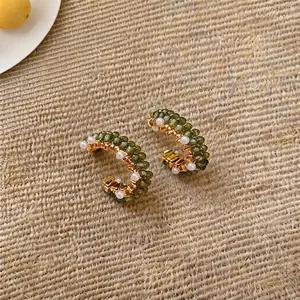 Forest style golden C-shaped hoop earrings featuring green beads and white pearls