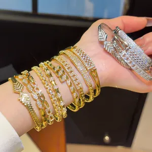 Detail of luxury 18K gold-plated bangles set with sparkling cubic zirconia stones