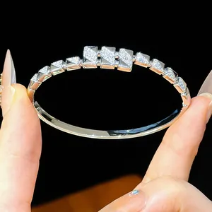 Macro detail of 18K gold plated buckle bangle with shimmering cubic zirconia stones
