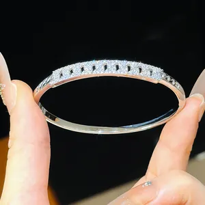 Detailed macro view of 18K gold plated silver bangle encrusted with sparkling zircon stones