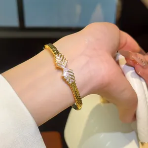 Close-up of elegant 18K gold plated zircon bracelet with interlocking arrow design for women