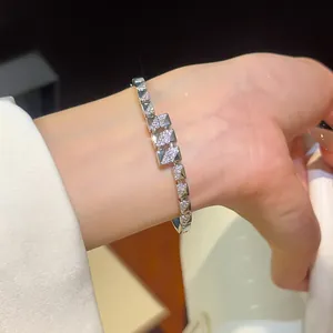 Close-up of elegant 18K gold-plated geometric bracelet with sparkling zircons on wrist