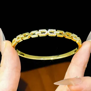 Detailed view of an 18K gold-plated bangle with sparkling zircon pavé link design.