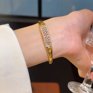 Elegant 18K gold plated bangle with sparkling zircon pavé for a luxury fashion look.