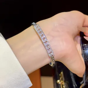 Detailed view of an 18K gold plated bracelet with sparkling zirconia stones on a wrist