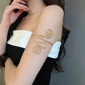 Detailed macro shot of a stylish gold spiral metal armlet worn on the upper arm