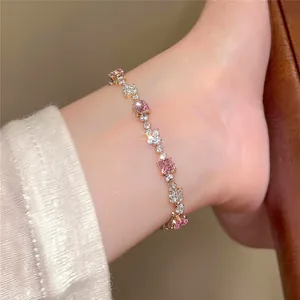 Close-up view of an elegant sparkling bracelet with pink square zircons on the wrist