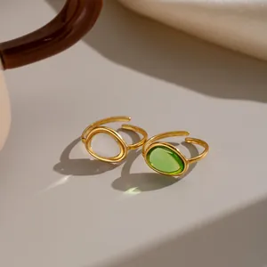 Close-up of vintage 18K gold plated stainless steel rings with green and white gems